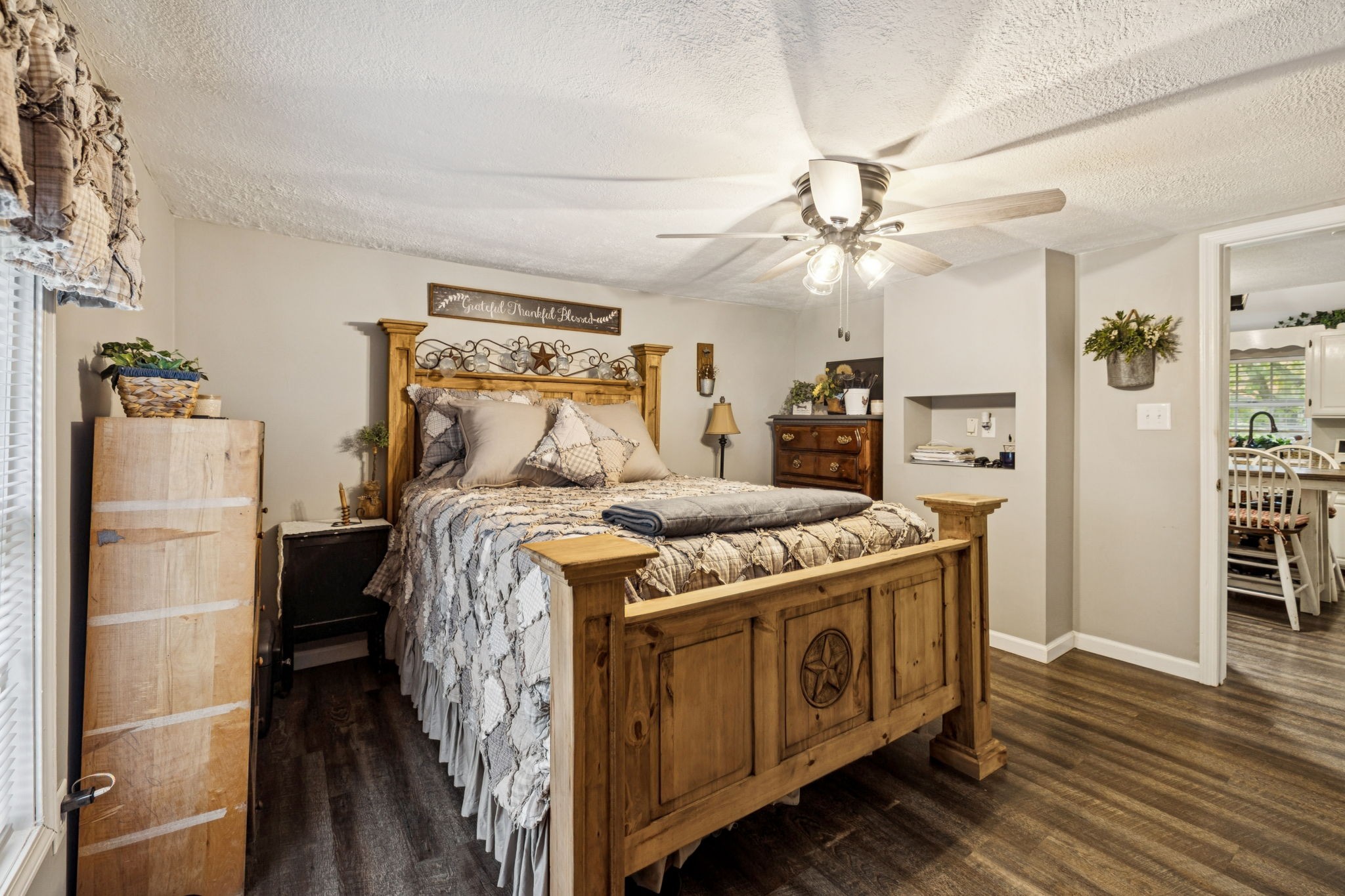 120 Tuttle Lane Bethpage, TN 37022 - Photo 13 of 26 a bed sitting in a kitchen next to a kitchen with cabinets and wooden floor