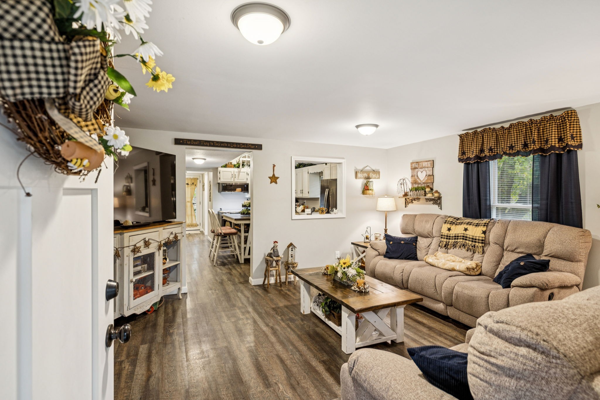 120 Tuttle Lane Bethpage, TN 37022 - Photo 6 of 26 a living room with furniture a flat screen tv and a floor to ceiling window
