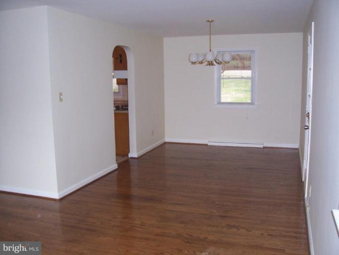4412 Henderson Road Temple Hills, MD 20748 - Photo 7 of 13 a view of an empty room with wooden floor and a window