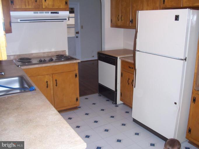 4412 Henderson Road Temple Hills, MD 20748 - Photo 8 of 13 a kitchen with a refrigerator and a stove
