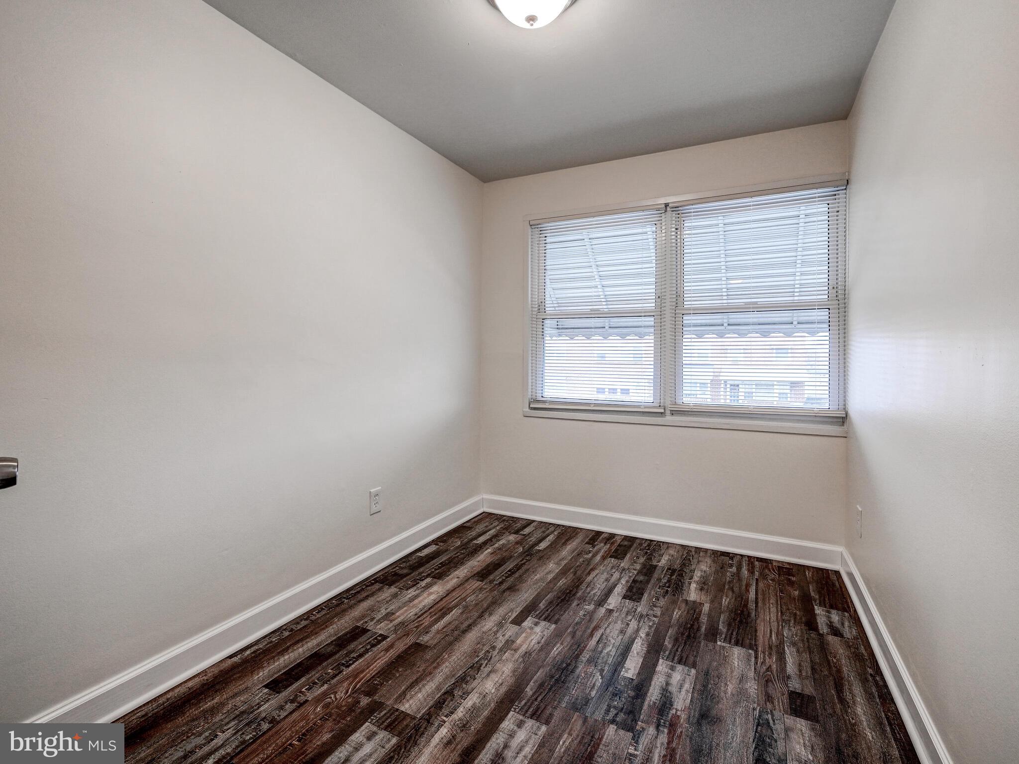 8127 Del Haven Road Dundalk, MD 21222 - Photo 13 of 25 a view of a room with wooden floor and window