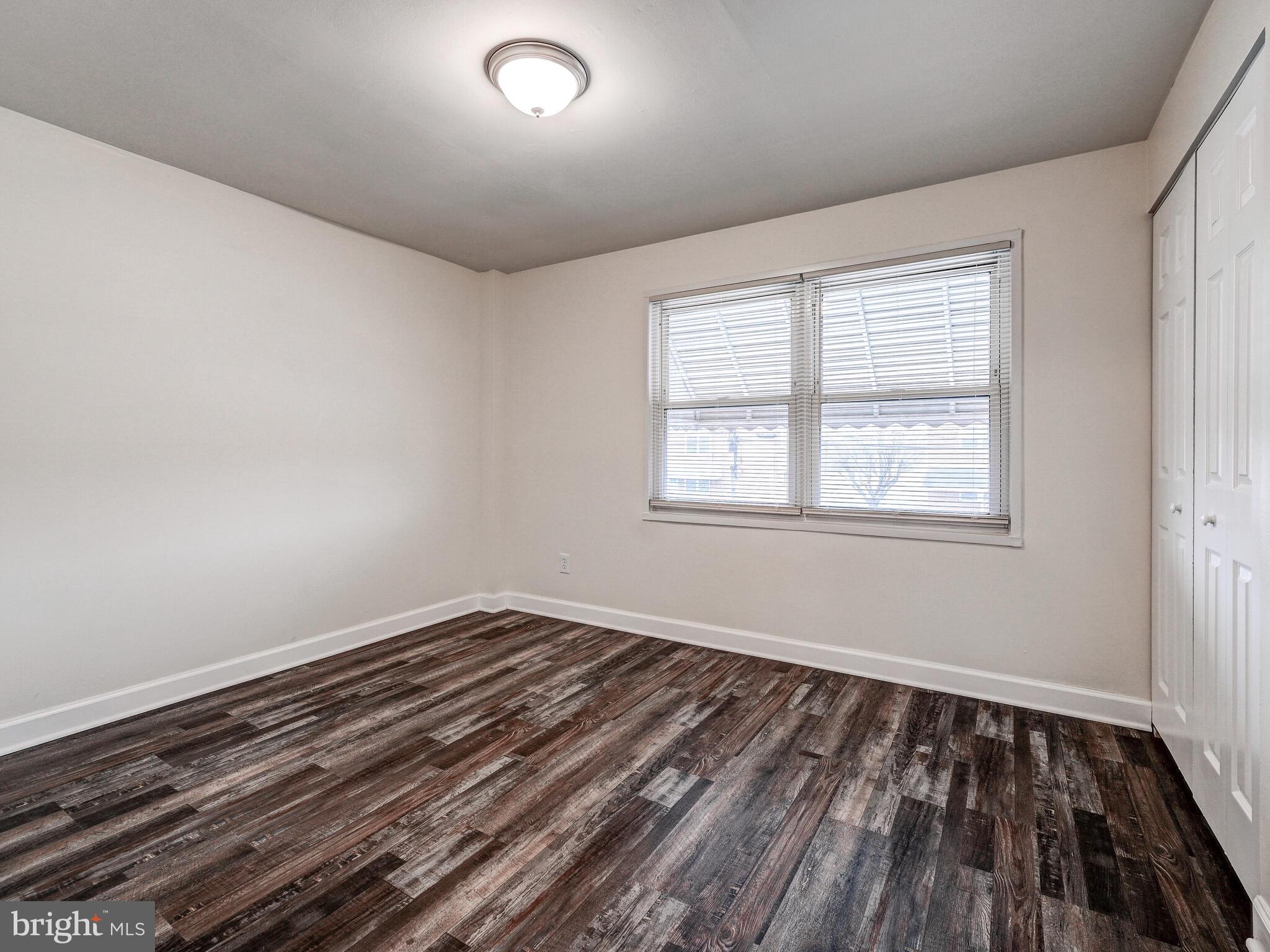 8127 Del Haven Road Dundalk, MD 21222 - Photo 17 of 25 wooden floor in an empty room with a window