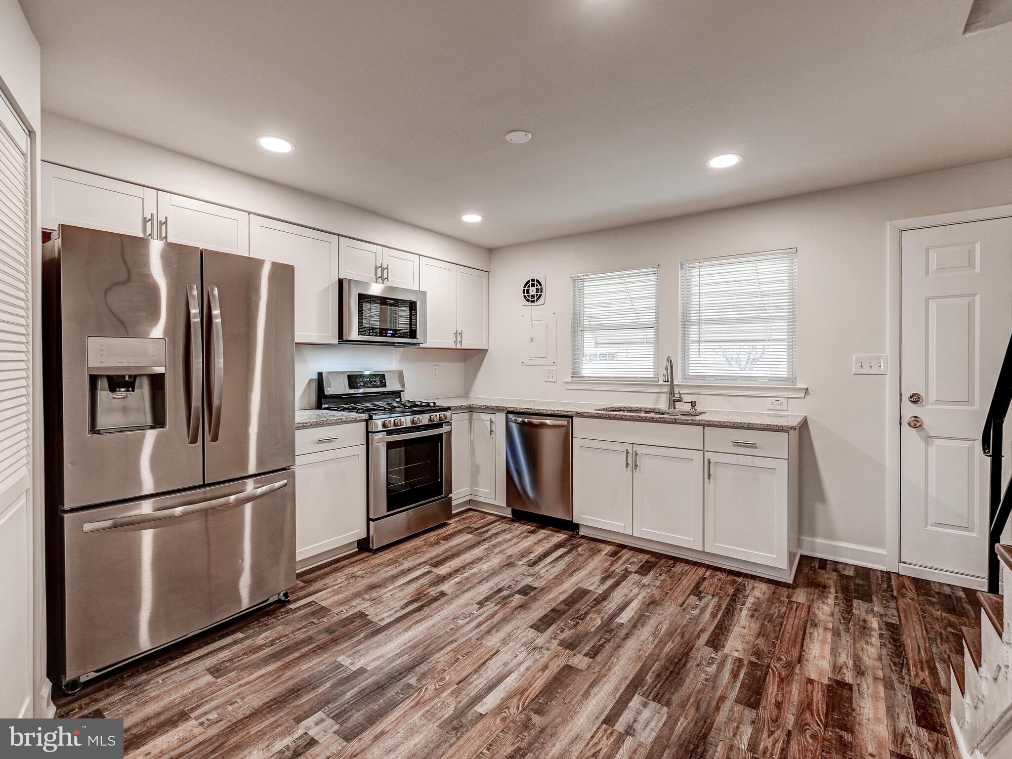 8127 Del Haven Road Dundalk, MD 21222 - Photo 5 of 25 a kitchen with a refrigerator stove and microwave
