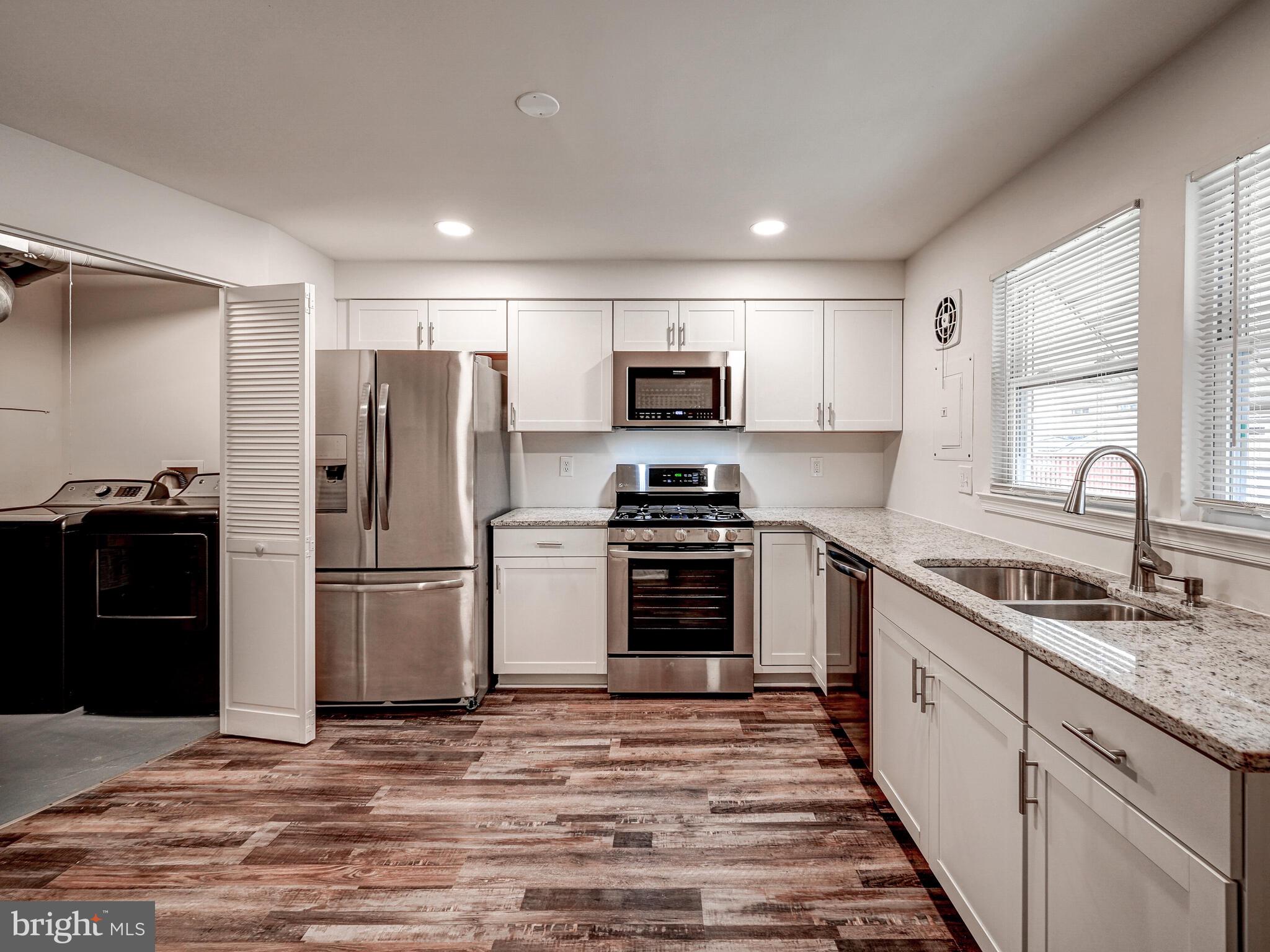 8127 Del Haven Road Dundalk, MD 21222 - Photo 7 of 25 a kitchen with refrigerator a microwave and cabinets