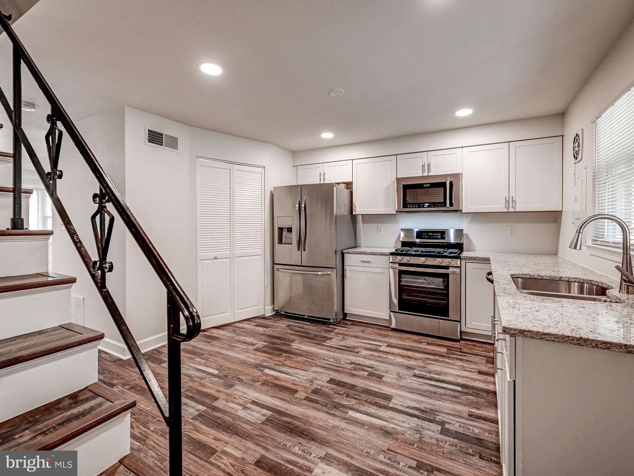 8127 Del Haven Road Dundalk, MD 21222 - Photo 8 of 25 a kitchen with kitchen island a sink appliances and cabinets