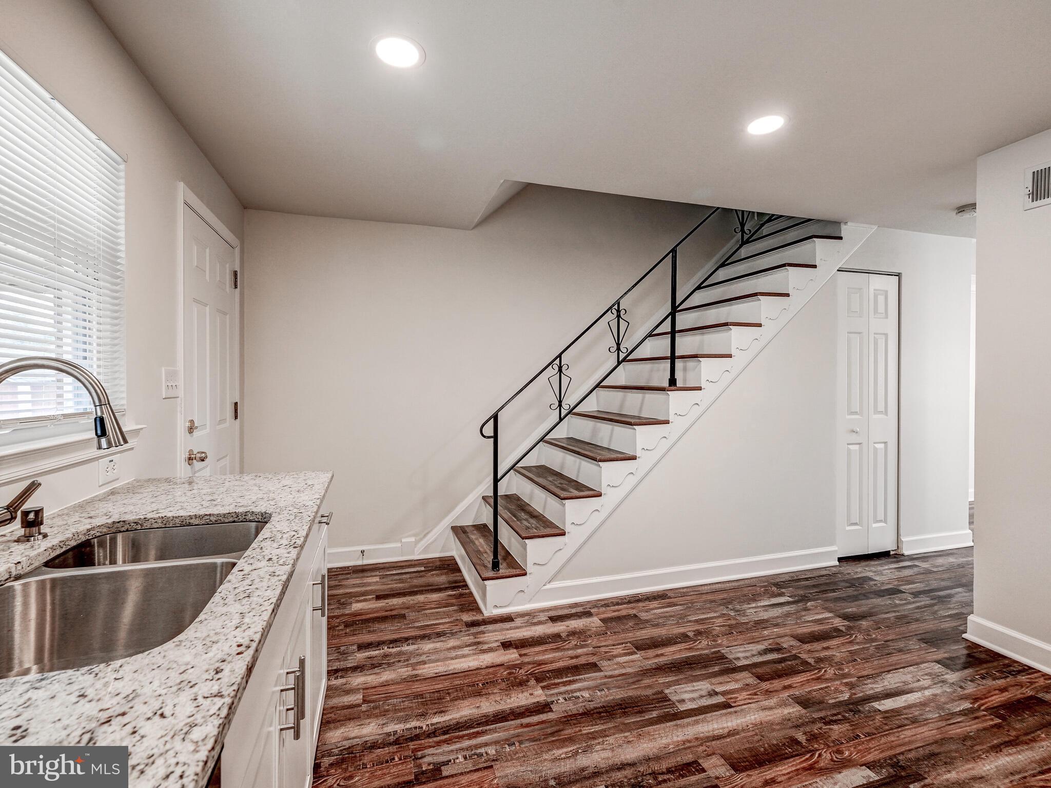 8127 Del Haven Road Dundalk, MD 21222 - Photo 9 of 25 a kitchen with a sink a stove and cabinets