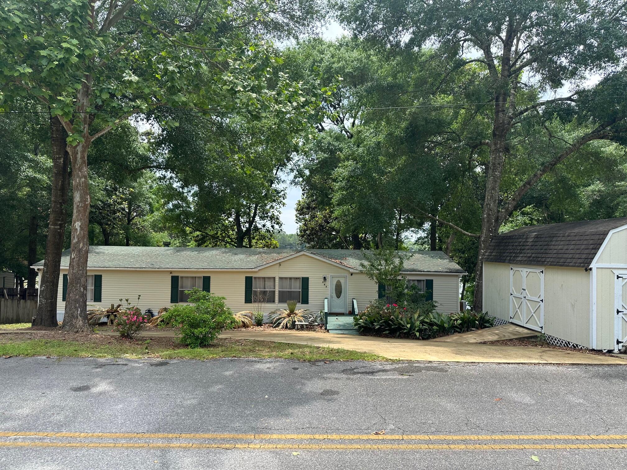 763 Squirrel Road DeFuniak Springs, FL 32433 - Photo 1 of 28 a front view of a house with a garden