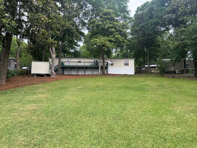 763 Squirrel Road DeFuniak Springs, FL 32433 - Photo 17 of 28 a view of a house with a backyard and sitting area