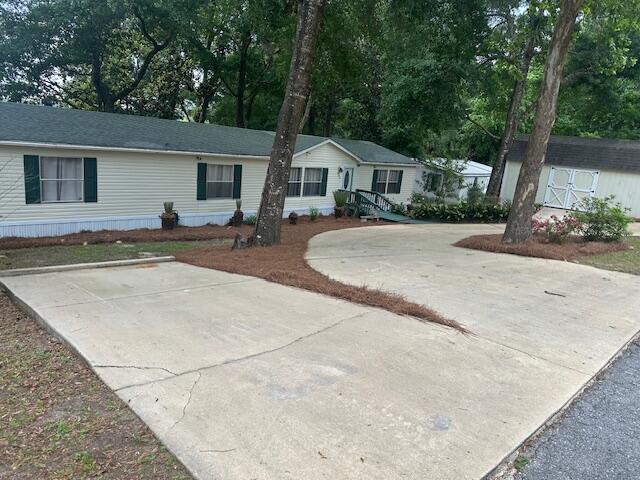 763 Squirrel Road DeFuniak Springs, FL 32433 - Photo 3 of 28 a front view of a house with a yard and trees
