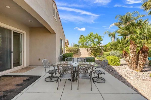 a view of a patio with table and chairs and potted plants