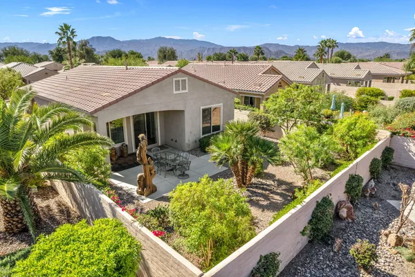 a view of a patio with table and chairs and potted plants