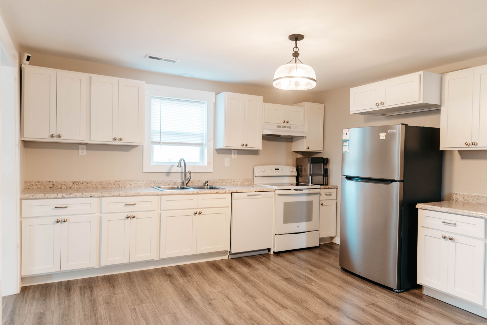2470 Hinton Road Clarksville, TN 37043 - Photo 8 of 34 a kitchen with a refrigerator a sink and dishwasher with white cabinets