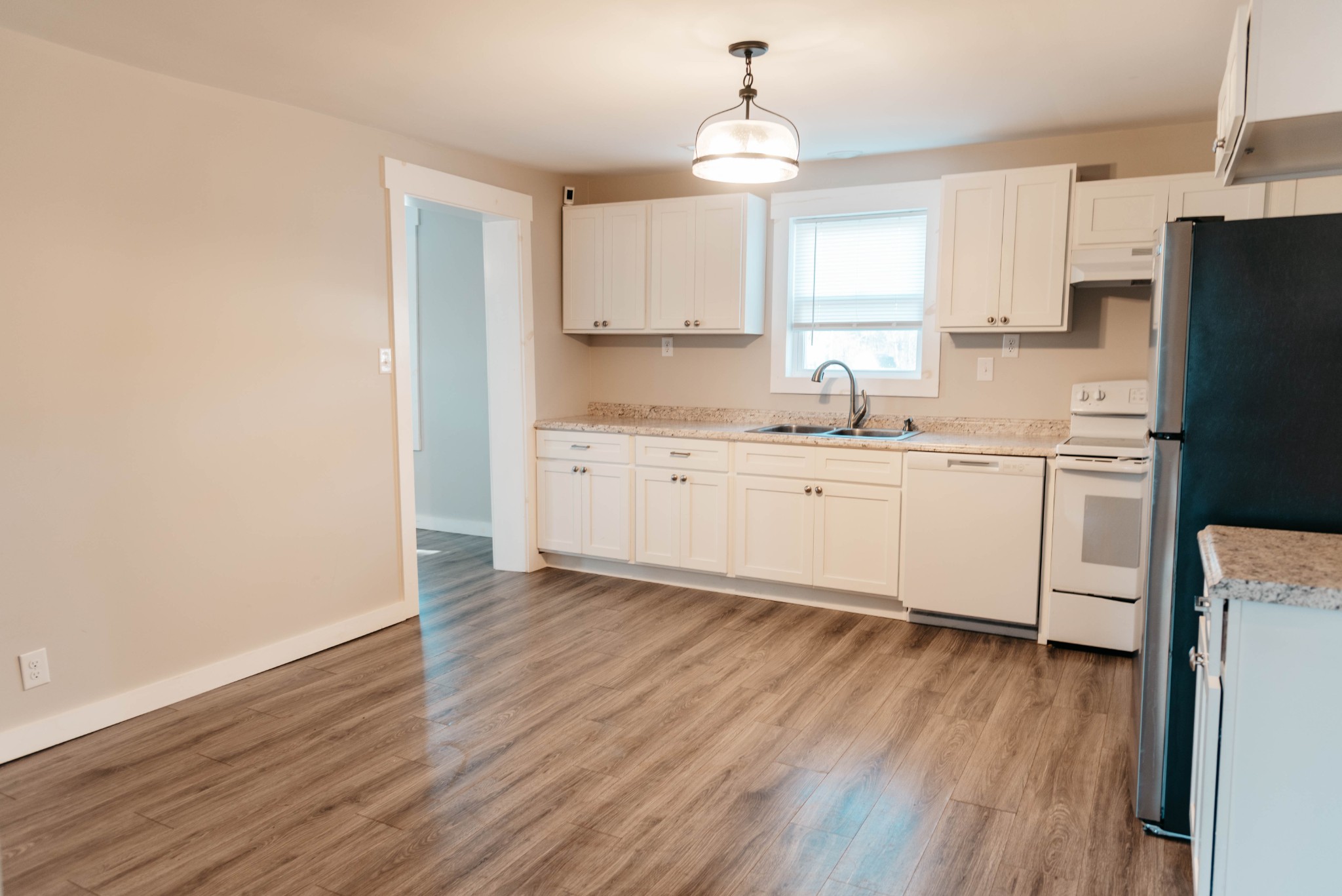 2470 Hinton Road Clarksville, TN 37043 - Photo 9 of 34 a kitchen with stainless steel appliances a sink cabinets and wooden floor