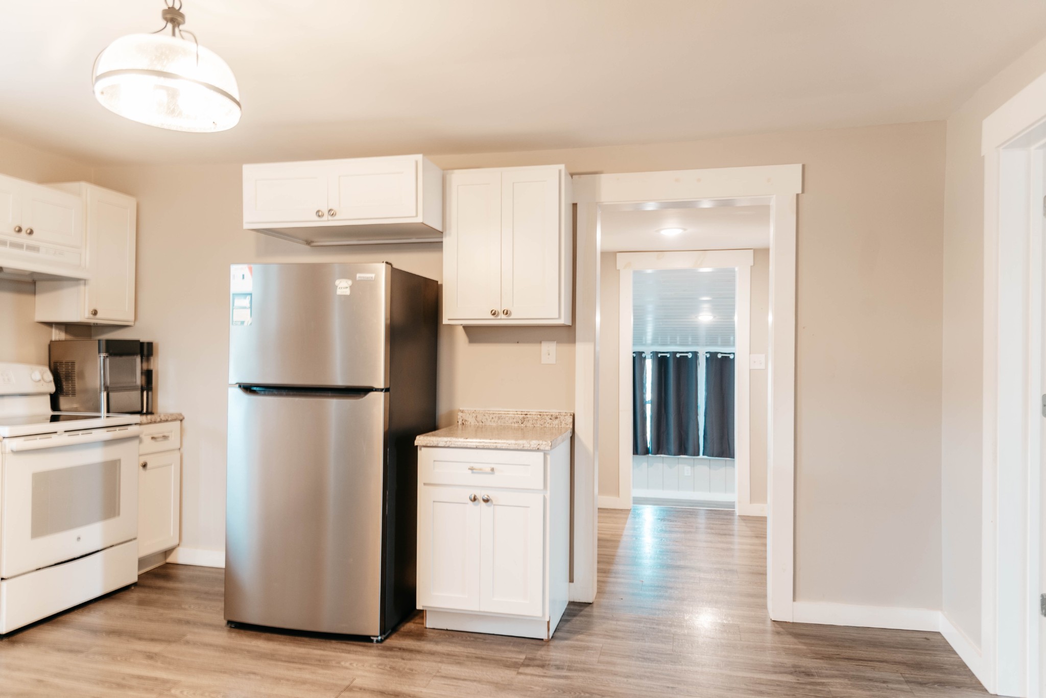 2470 Hinton Road Clarksville, TN 37043 - Photo 10 of 34 a kitchen with refrigerator a stove and wooden floor
