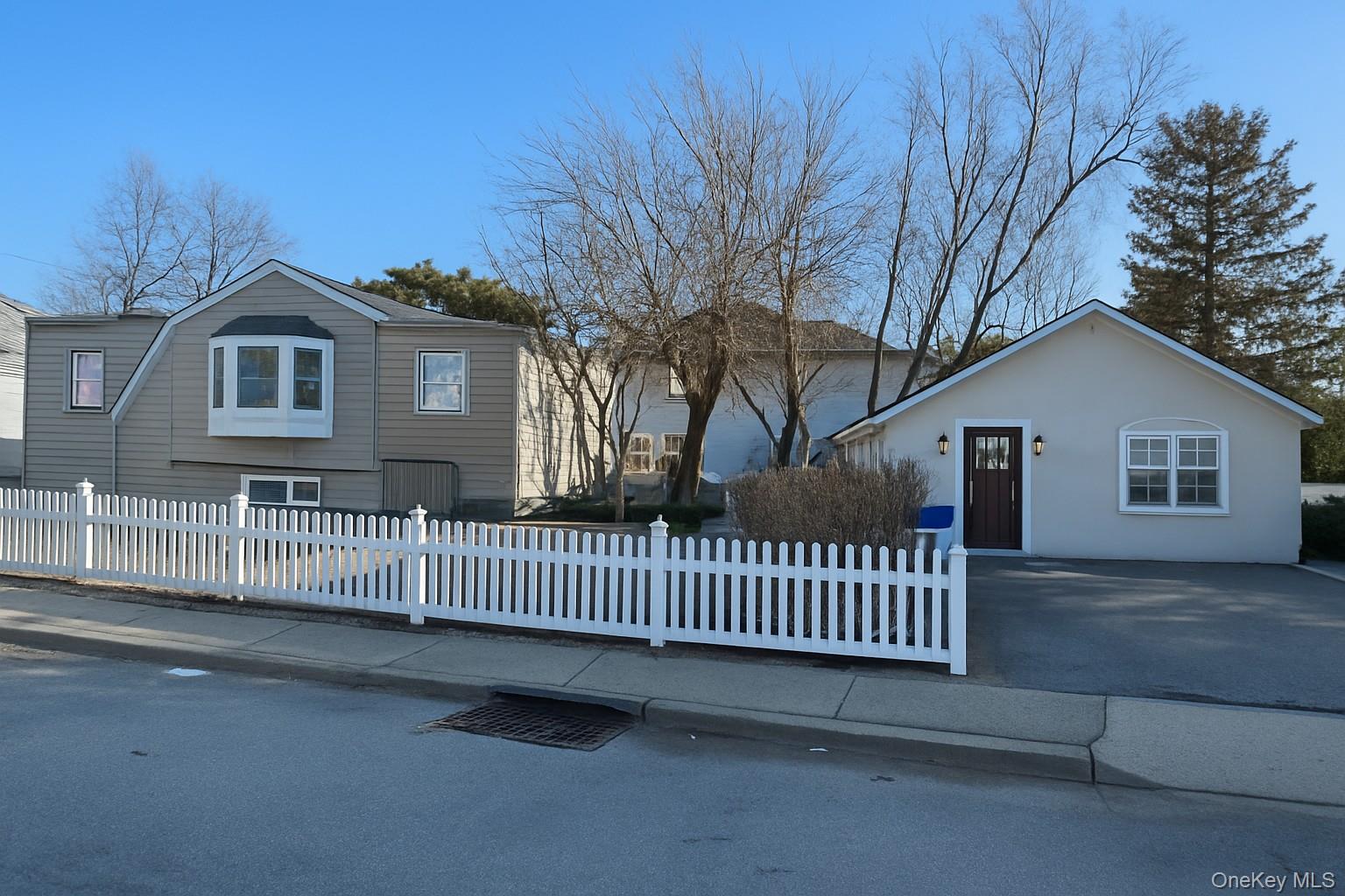 a view of a house with a street view and a fence