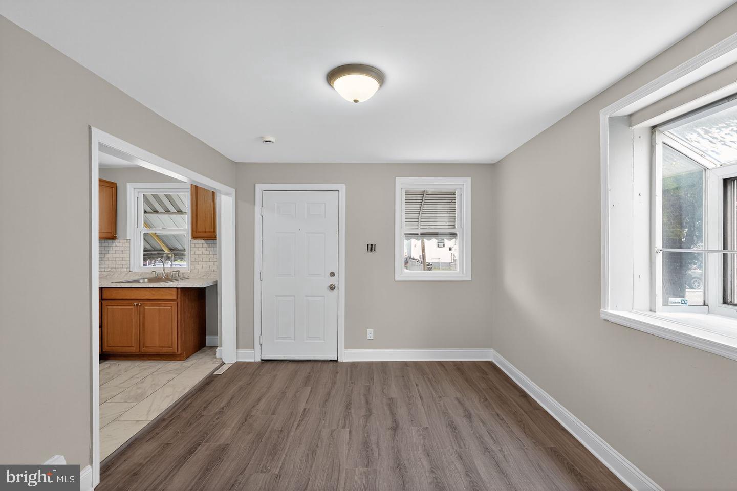 1001 Burnside Road Sharon Hill, PA 19079 - Photo 3 of 21 a view of an empty room with a window and wooden floor