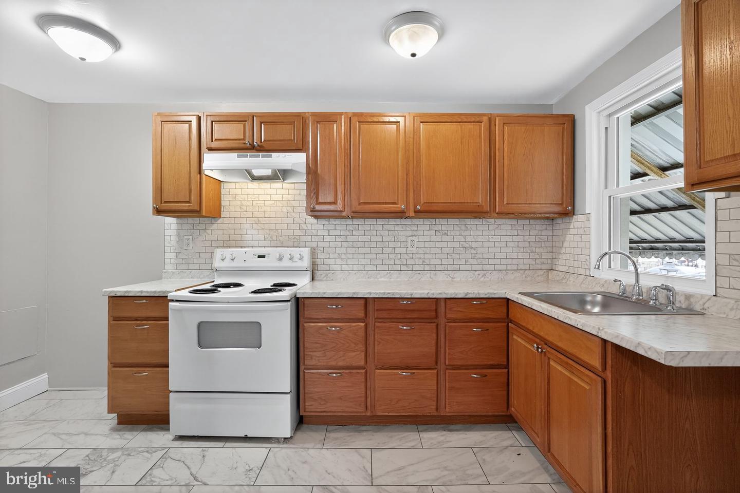 1001 Burnside Road Sharon Hill, PA 19079 - Photo 5 of 21 a kitchen with a sink stove top oven and cabinets