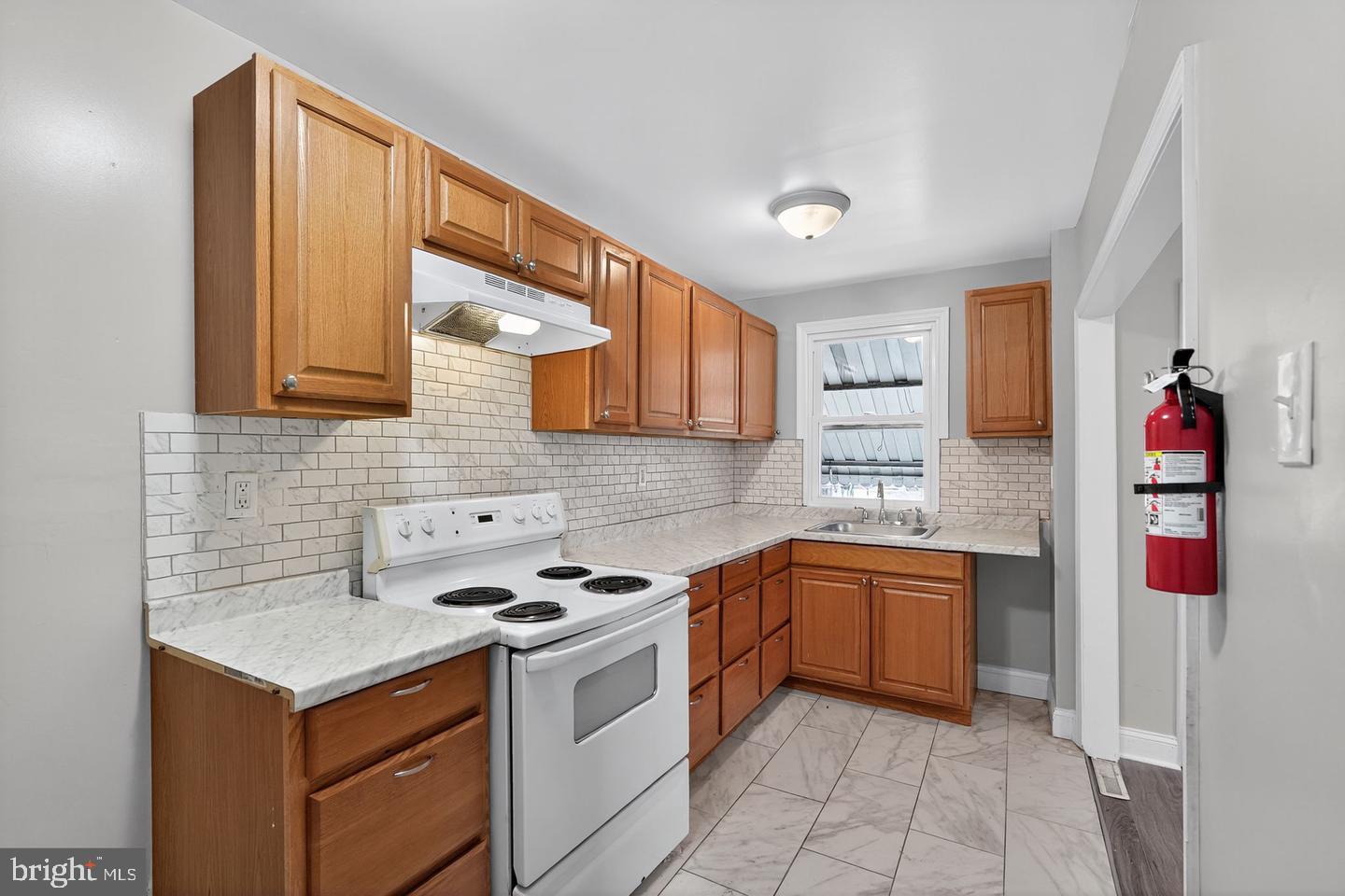 1001 Burnside Road Sharon Hill, PA 19079 - Photo 6 of 21 a kitchen with stainless steel appliances granite countertop a stove sink and cabinets