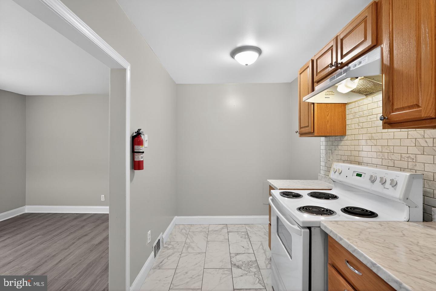 1001 Burnside Road Sharon Hill, PA 19079 - Photo 7 of 21 a kitchen with a stove and a refrigerator