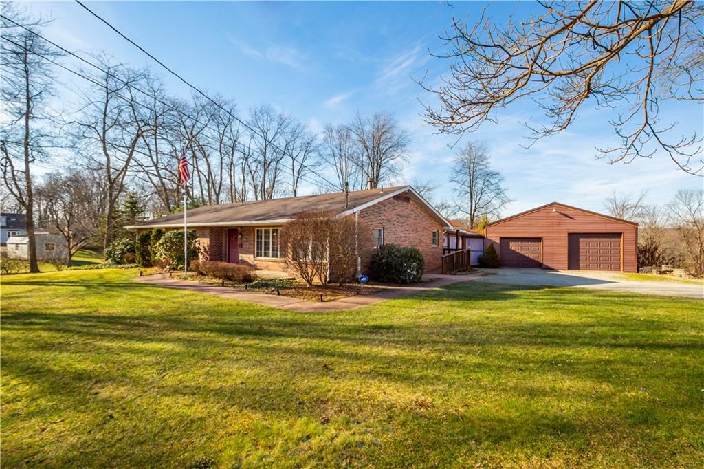105 Trump Road Cheswick, PA 15024 - Photo 1 of 25 a front view of house with yard and trees in front of it