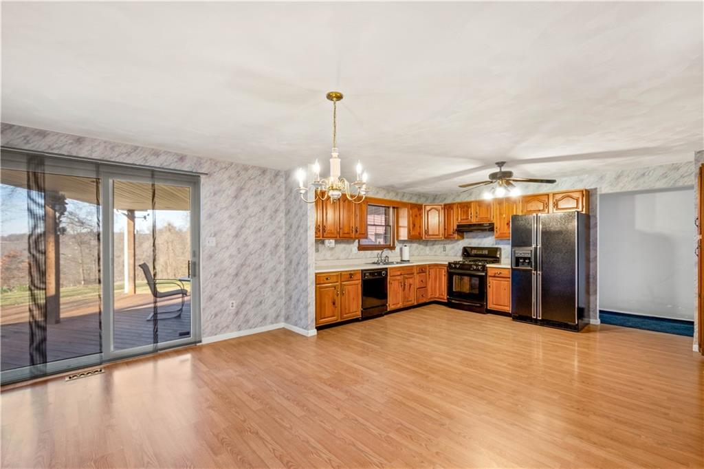105 Trump Road Cheswick, PA 15024 - Photo 8 of 25 a kitchen with stainless steel appliances kitchen island granite countertop a refrigerator a sink a stove and a wooden floors