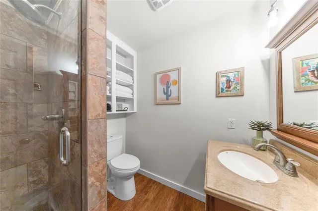 a bathroom with a granite countertop toilet sink and a mirror