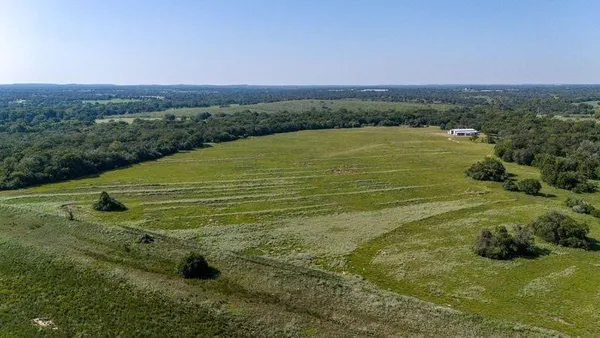 a view of a field with an ocean