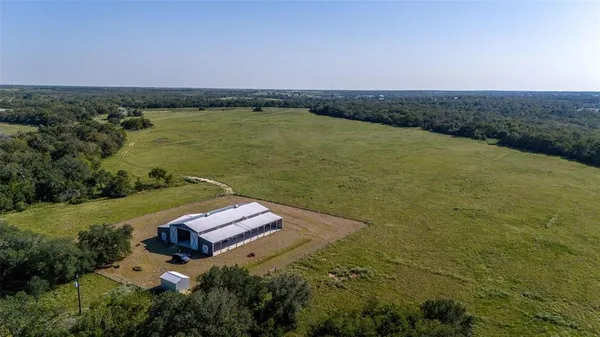 an aerial view of a house with a yard