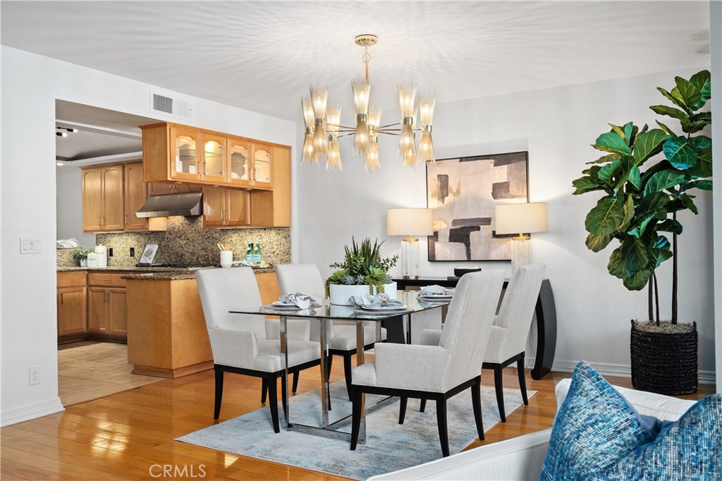 11687 Bellagio Road, Unit 12 Los Angeles, CA 90049 - Photo 13 of 50 Formal dining room adjacent to the kitchen, allowing a natural flow from preparation to presentation, with direct access to the front balcony for additional outdoor seating.