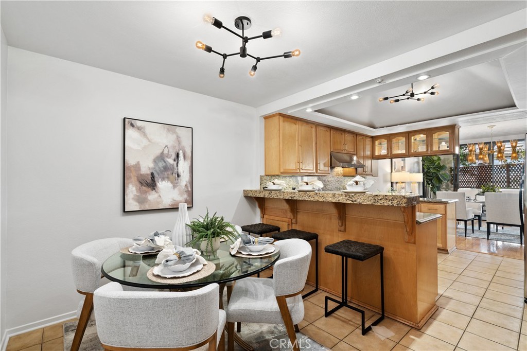 11687 Bellagio Road, Unit 12 Los Angeles, CA 90049 - Photo 16 of 50 Multi purpose nook with breakfast bar seating, a built in work desk, and flexible space ideal for a home office, creative studio, or casual dining.