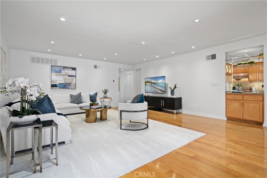 11687 Bellagio Road, Unit 12 Los Angeles, CA 90049 - Photo 2 of 50 Living spaces and kitchen connected by a built in wet bar with a sink, allowing effortless preparation and serving while remaining engaged with guests.