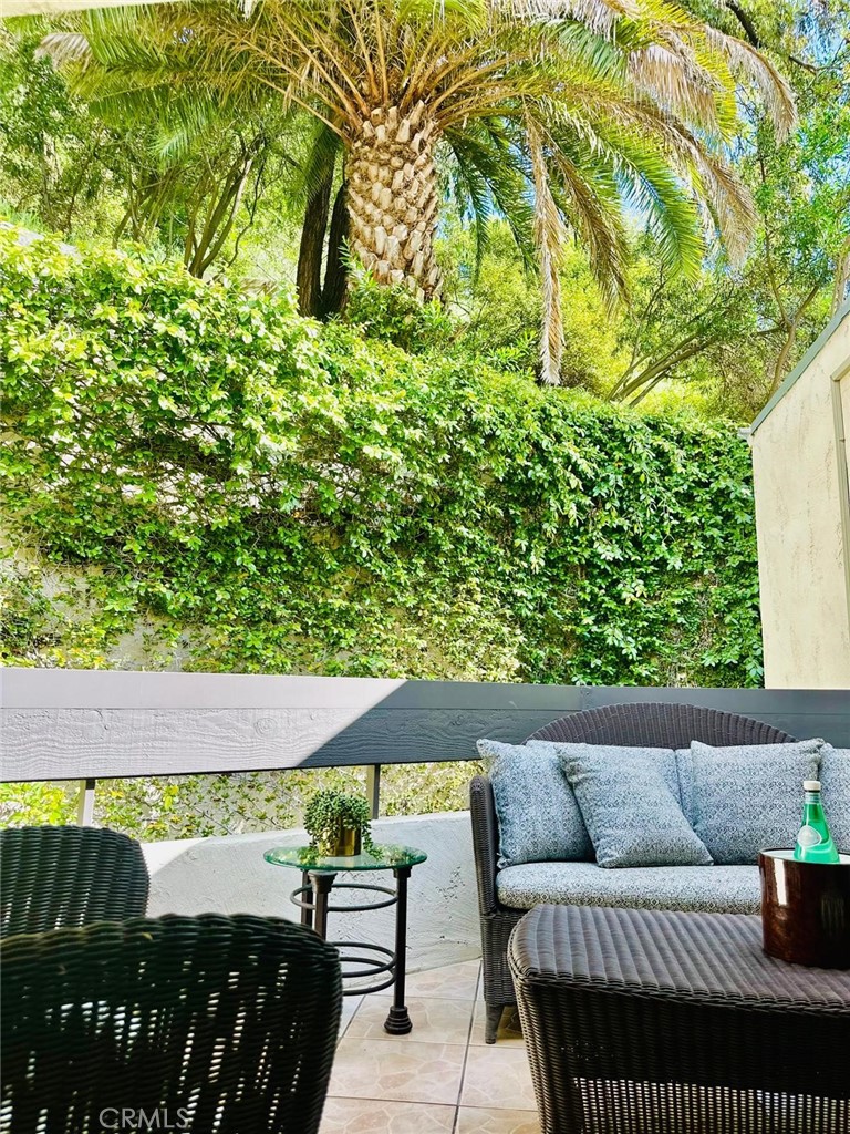 11687 Bellagio Road, Unit 12 Los Angeles, CA 90049 - Photo 29 of 50 Back balcony - tucked into the hillside of Bel Air