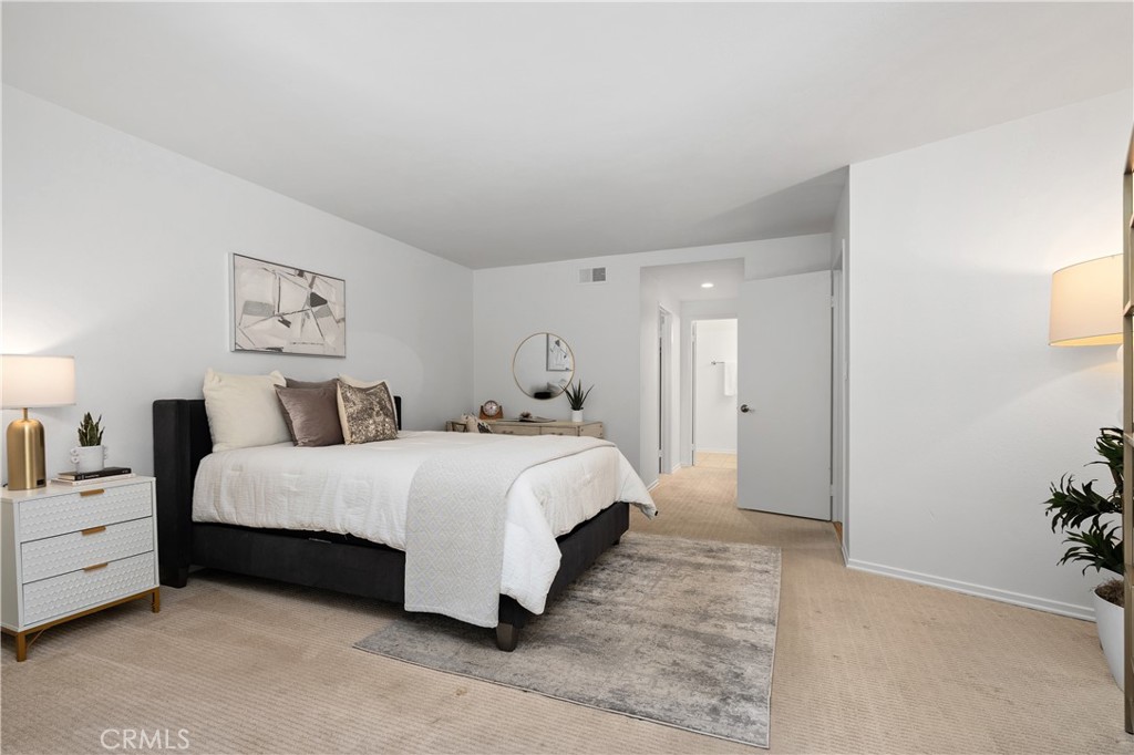 11687 Bellagio Road, Unit 12 Los Angeles, CA 90049 - Photo 32 of 50 Second bedroom suite complete with its own walk in closet and full bath with enclosed shower and water closet, offering flexibility for guests, extended stays, or creative pursuits.