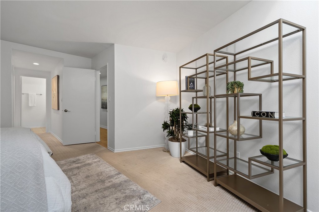 11687 Bellagio Road, Unit 12 Los Angeles, CA 90049 - Photo 33 of 50 Second bedroom suite complete with its own walk in closet and full bath with enclosed shower and water closet, offering flexibility for guests, extended stays, or creative pursuits.