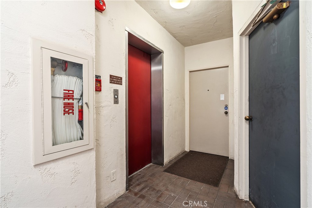 11687 Bellagio Road, Unit 12 Los Angeles, CA 90049 - Photo 37 of 50 Semi private elevator access opens to a landing shared with only one neighboring residence.