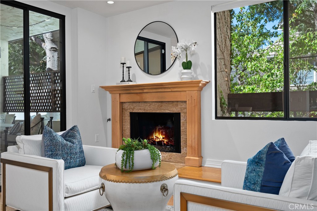 11687 Bellagio Road, Unit 12 Los Angeles, CA 90049 - Photo 6 of 50 Digitally enhanced fireplace with flames.