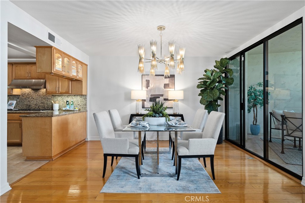 11687 Bellagio Road, Unit 12 Los Angeles, CA 90049 - Photo 8 of 50 Formal dining room adjacent to the kitchen with direct access to the front balcony, allowing indoor dining to flow naturally to additional outdoor seating for entertaining.