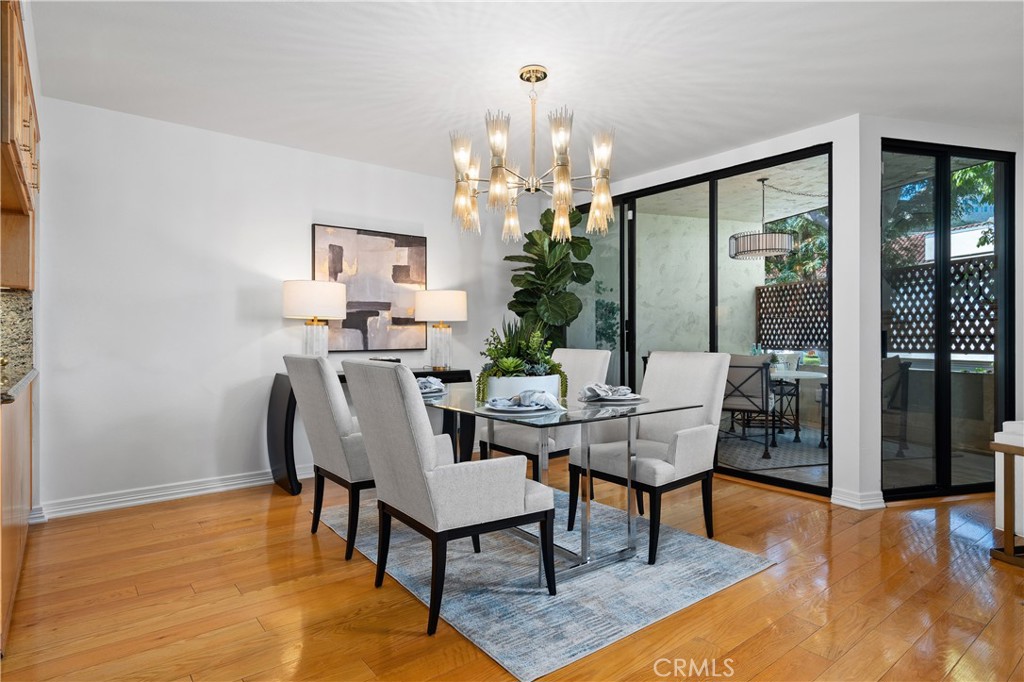11687 Bellagio Road, Unit 12 Los Angeles, CA 90049 - Photo 9 of 50 Formal dining room adjacent to the kitchen with direct access to the front balcony, allowing indoor dining to flow naturally to additional outdoor seating for entertaining.