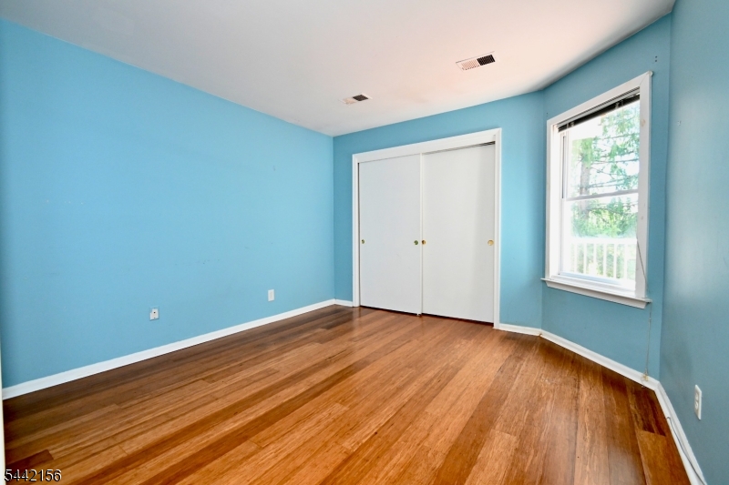4 Cedar Court Bedminster, NJ 07921 - Photo 8 of 16 a view of an empty room with wooden floor and a window