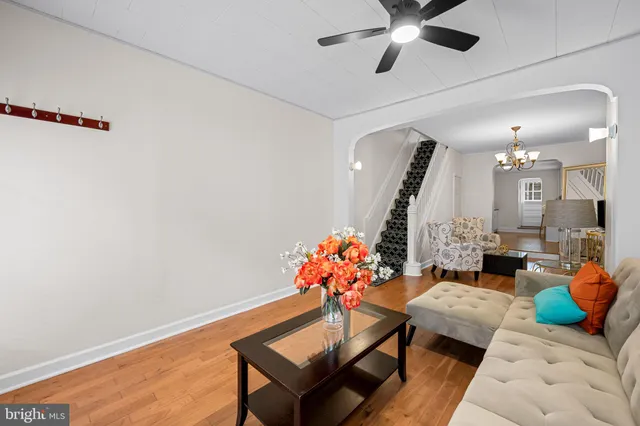 a living room with furniture and wooden floor