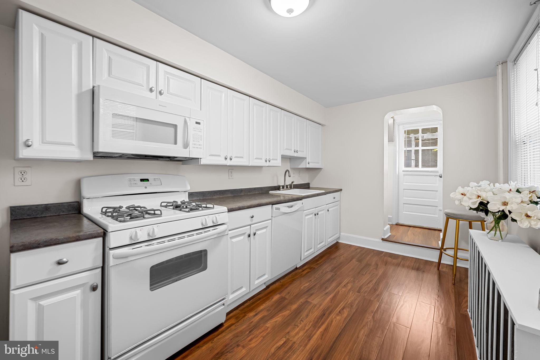 417 South Madeira Street Baltimore, MD 21231 - Photo 14 of 33 a kitchen with white cabinets and white appliances