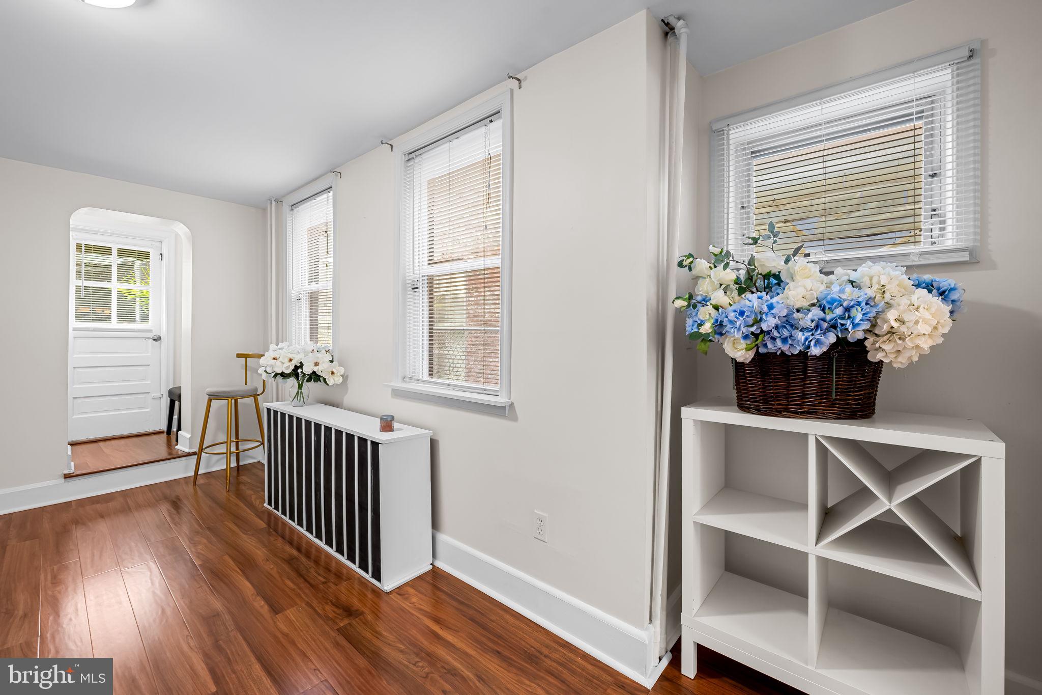 417 South Madeira Street Baltimore, MD 21231 - Photo 15 of 33 a view of a dining room with wooden floor windows and a chandelier
