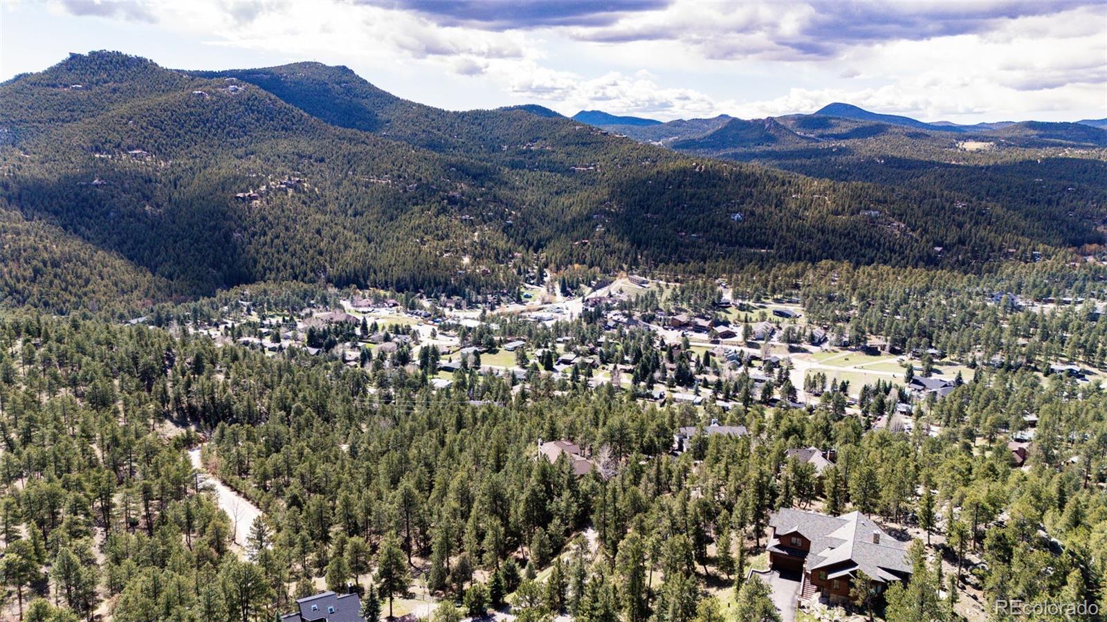 4094 Alpine Drive Evergreen, CO 80439 - Photo 11 of 39 a view of a house with a mountain
