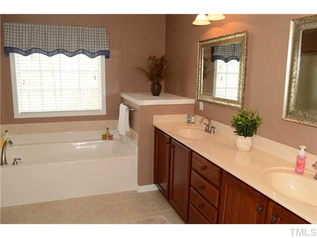 4457 Fairview Ridge Lane Apex, NC 27539 - Photo 11 of 25 Upgraded ceramic tile flooring, satin nickel faucets, bronze cabinet hardware and lighting create the spa retreat bath.