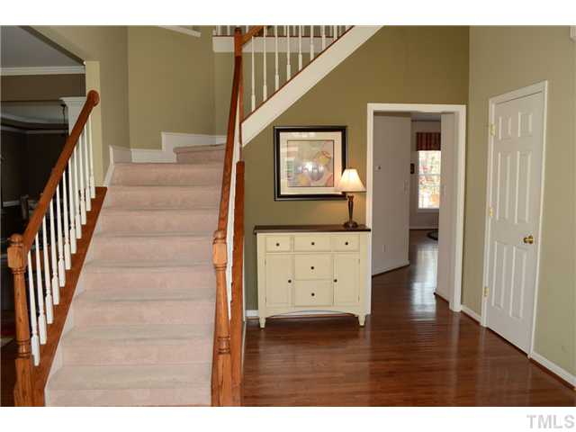 4457 Fairview Ridge Lane Apex, NC 27539 - Photo 2 of 25 Two story oak hardwood flooring foyer with corner art niche and oil rubbed bronze chandelier.