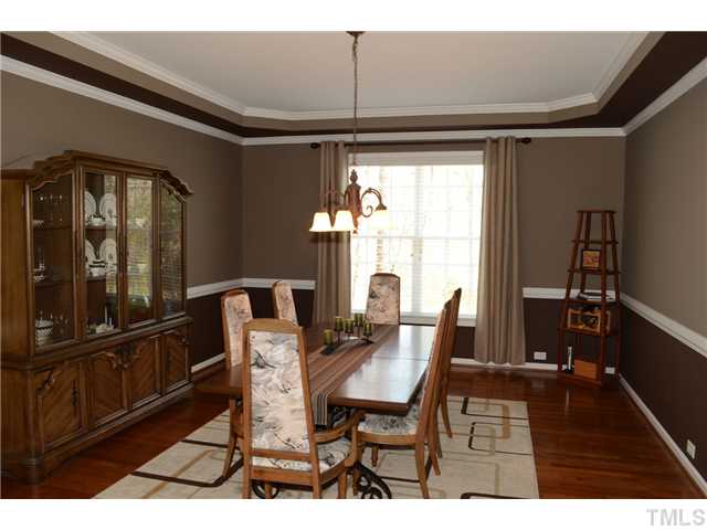 4457 Fairview Ridge Lane Apex, NC 27539 - Photo 4 of 25 Banquet sized 18x14 dining room featuring tray ceiling, crown and chair rail moldings. Windows are custom fitted with 2" blinds.