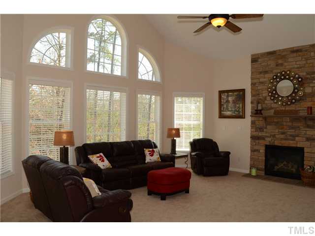 4457 Fairview Ridge Lane Apex, NC 27539 - Photo 8 of 25 Upgraded stacked stone fireplace. Back staircase to the bonus room/second floor is along the right wall. Staircase to the basement is along the back.