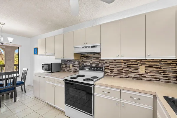 a kitchen with stainless steel appliances a refrigerator and a dining table