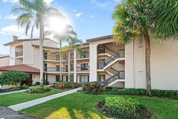 a front view of a multi story building with yard
