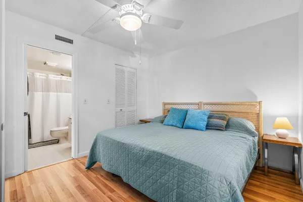 a bathroom with a granite countertop sink a toilet and a mirror